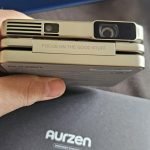 Aurzen ZIP Tri-Fold DLP Truly Mini Projector. Pocket Size. Zero-Lag Focus. One-Click Screen Mirroring. Full-Screen Mode. Type-C Fast Charging. 5.000mAh Battery. Indoor Outdoor Portable Projector.Gold photo review